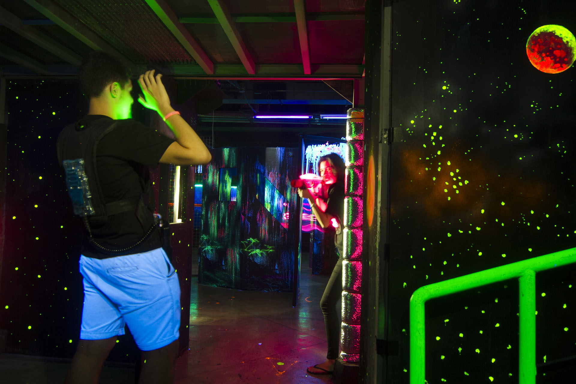 two people playing an indoor laser tag game