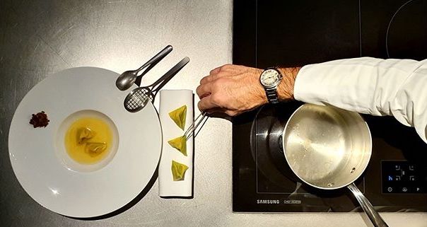Michelin star Chef Davide Oldani plating up ravioli in brodo