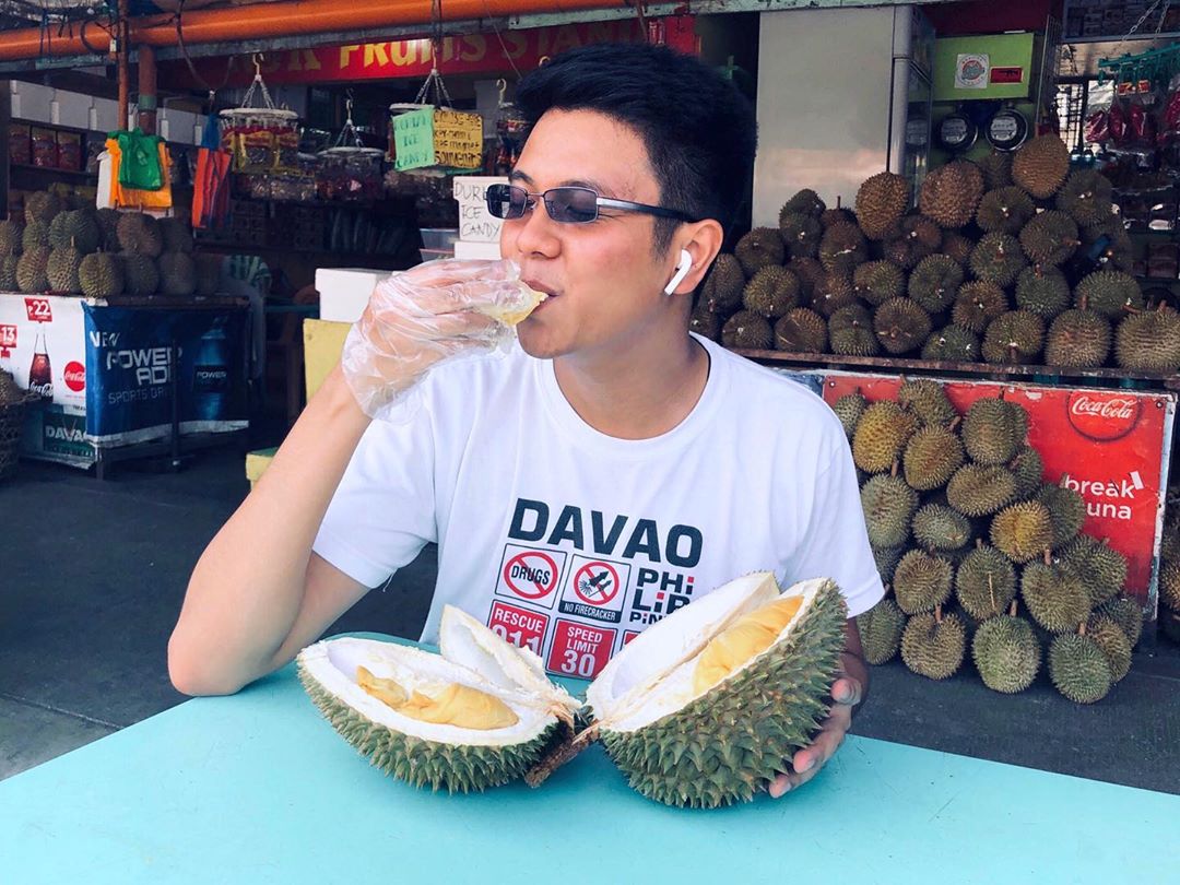 guy eating durians in davao