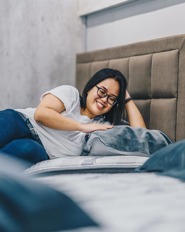 a lady trying out a bed