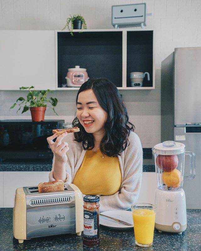 a lady eating toast