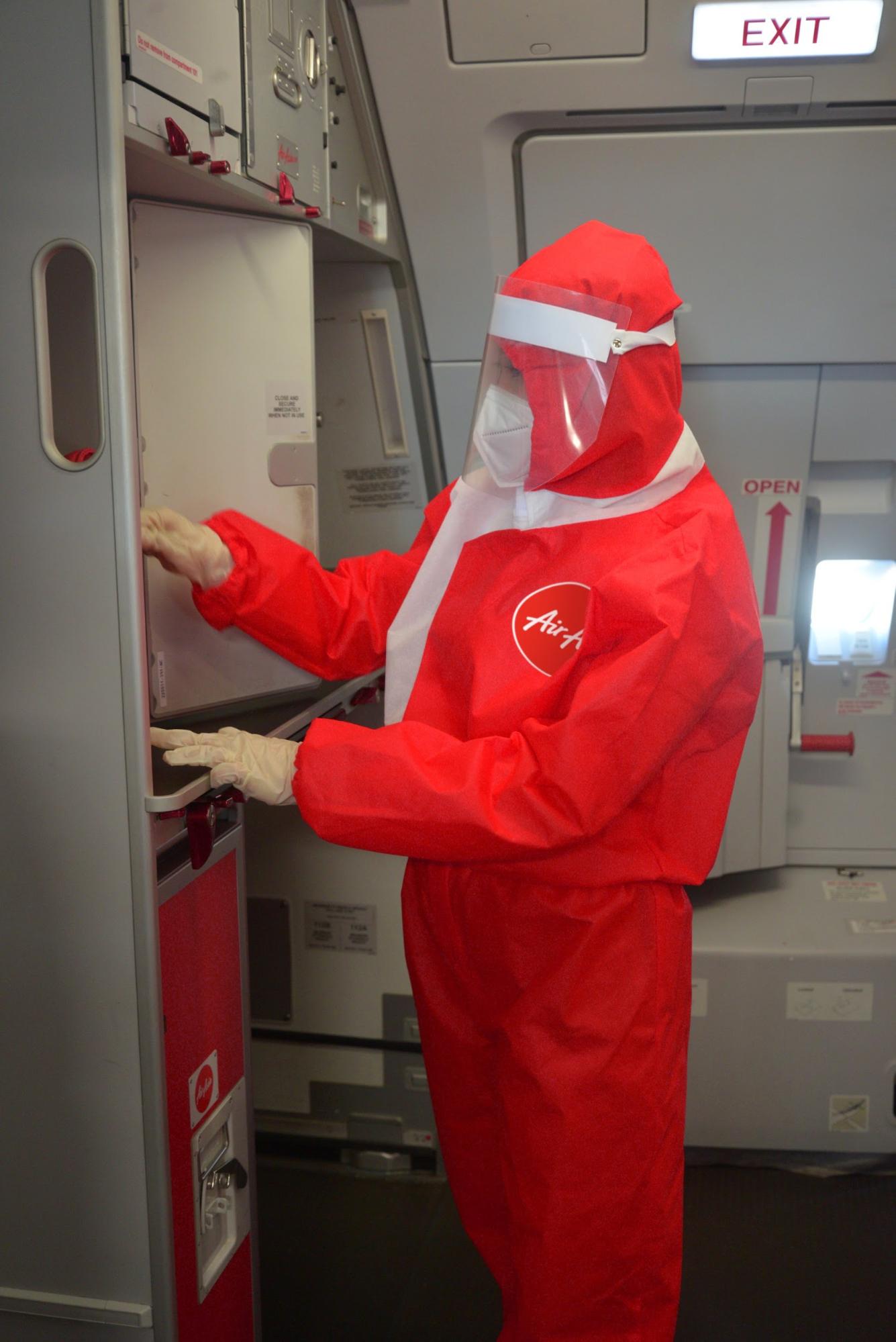 flight attendant wearing a red hazmat suit