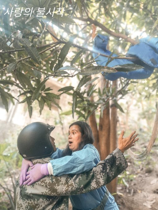 man dressed up as soldier catching woman falling from tree