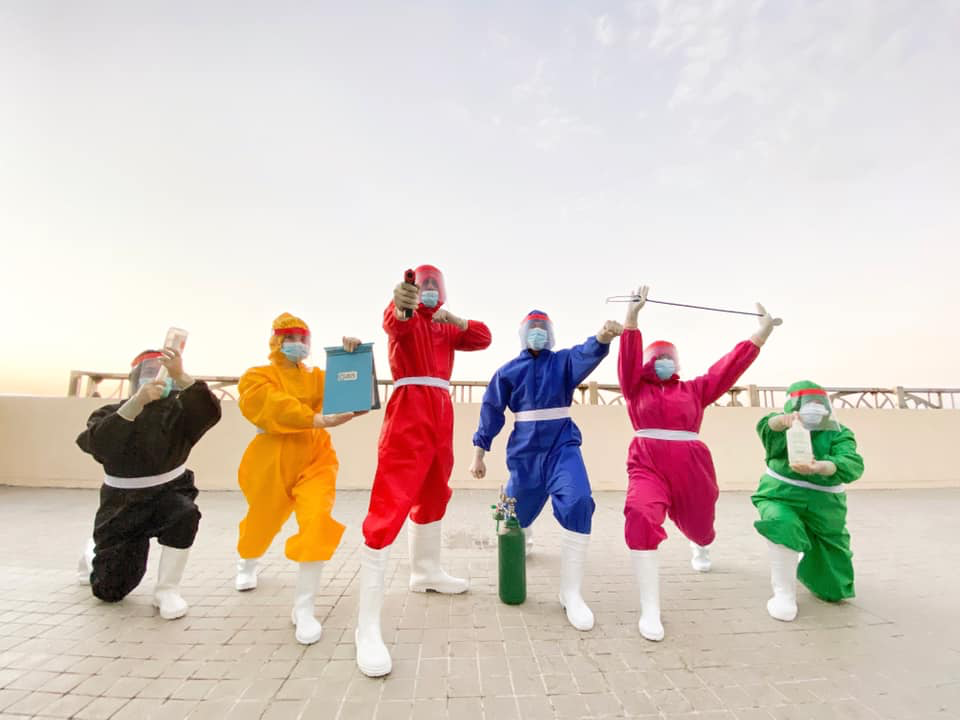 health workers in colorful hazmat suits 