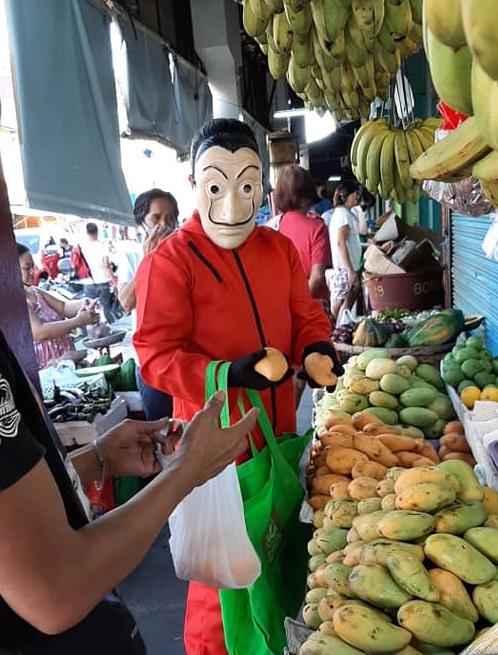 Dela Cruz buying goods from Angono market