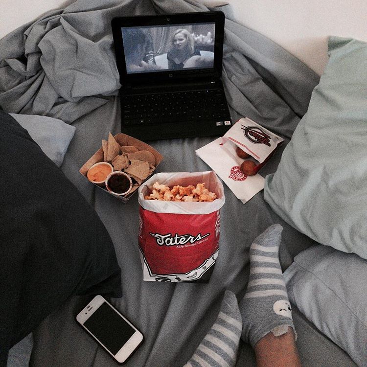 laptop and movie snacks in bed