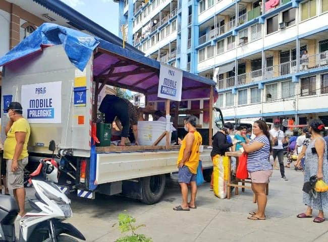 people buying from a mobile palengke