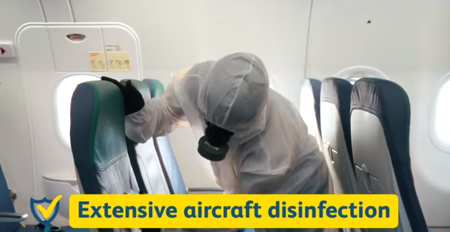 A crew disinfecting aircraft seats