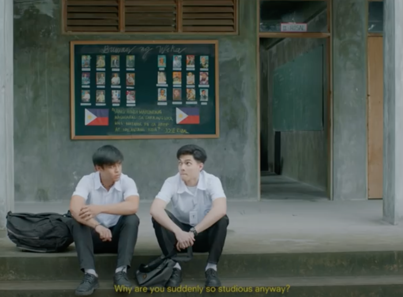 two boys sitting on the floor and talking