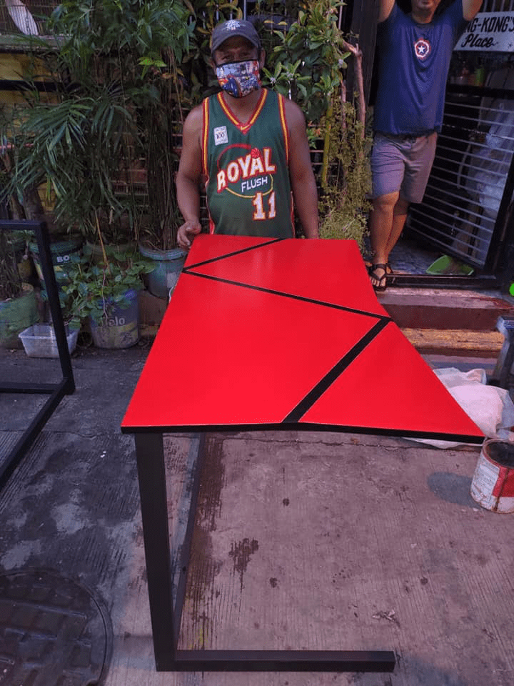 custom tables by jeepney drivers - man with red table