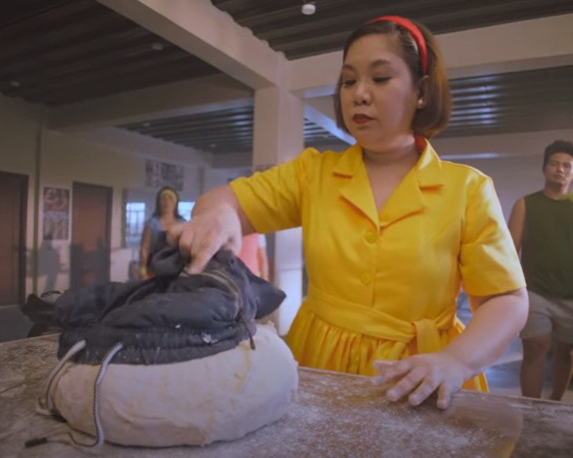 Julie's Bakeshop ad - Tita Julie preparing to roll the man-turned-dough into pandesal 