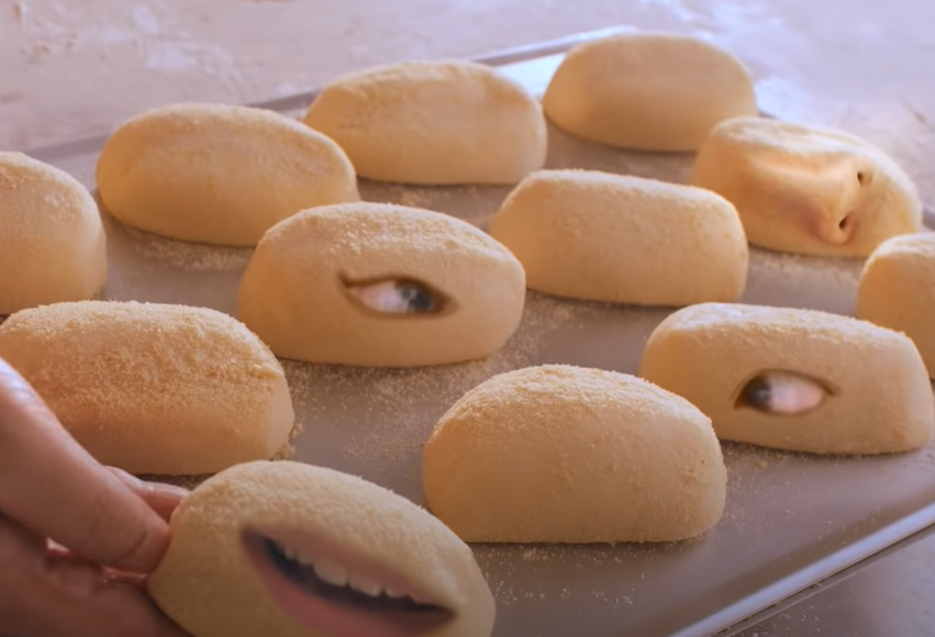 Julie's Bakeshop ad - the man's eyes, nose, and mouth appearing on several pieces of dough